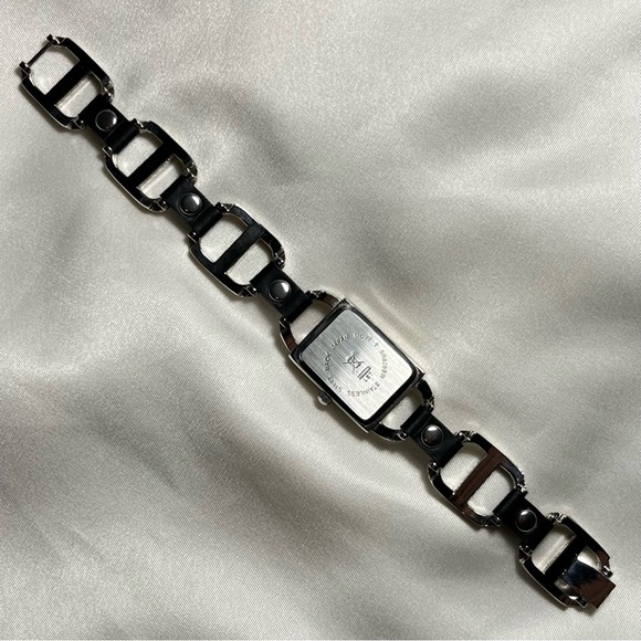 Silver tone buckle watch with black leather style grommets - Picture 3 of 4